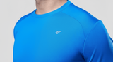 Close-up of a man wearing a blue active t-shirt with a logo on a light gray background