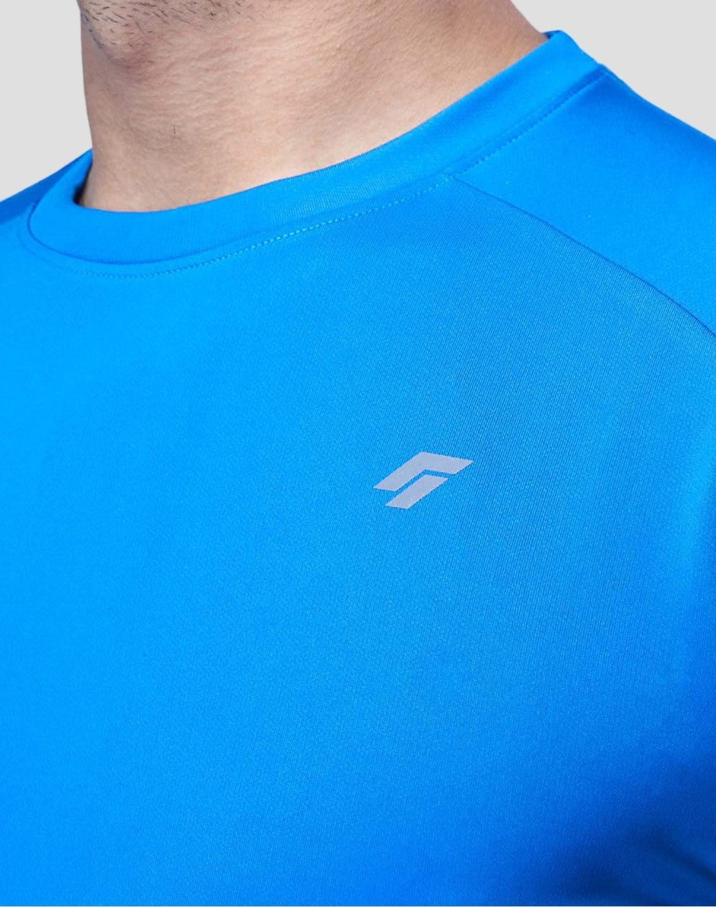 Blue active t-shirt with a logo on a plain background