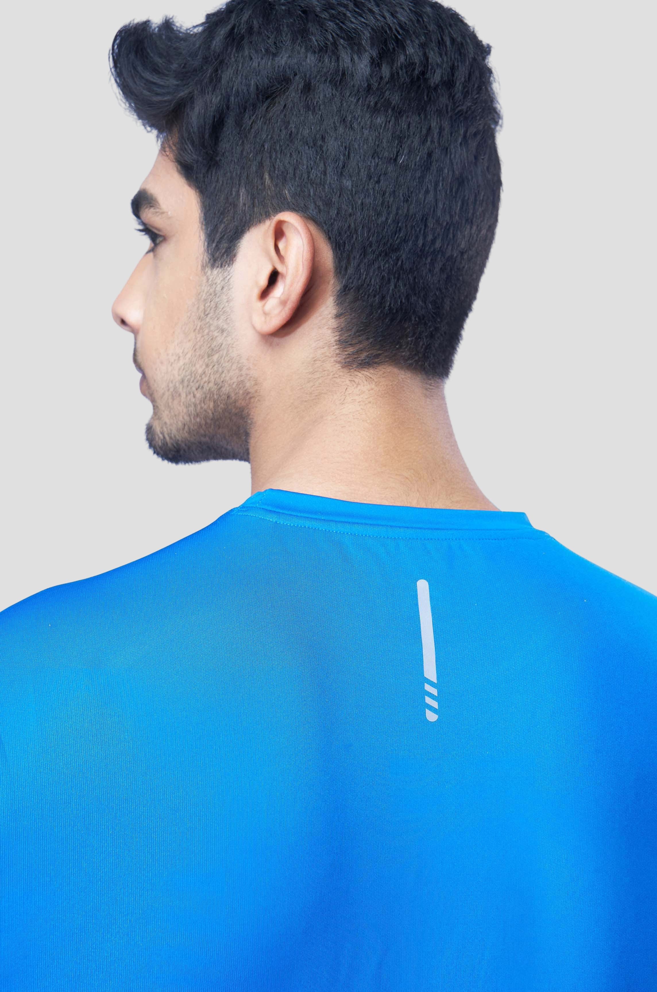 Back view of a man wearing a blue recycled polyester activewear t-shirt emphasizing the material.