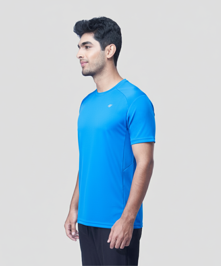 Man wearing a blue active  t-shirt on a light gray background