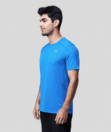 Man wearing a blue active  t-shirt on a light gray background
