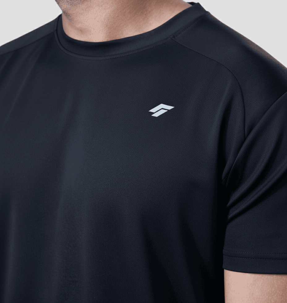 Close-up of man wearing black active t-shirt with a logo on a gray background