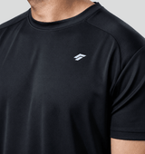 Close-up of man wearing black active t-shirt with a logo on a gray background