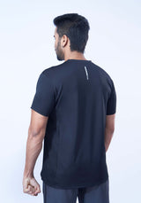 Back view of a man wearing a recycled polyester black activewear t-shirt against a white background.