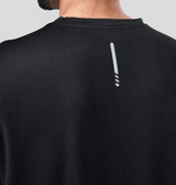 Back view of a man wearing a black activewear t-shirt against a gray background.