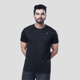Man wearing a black active t-shirt and gray joggers against a light gray background