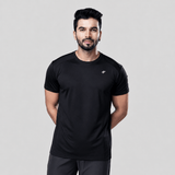 Man wearing a black active t-shirt and gray joggers against a light gray background