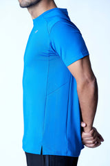 Male athlete showing the side design of a blue activewear tee with a split hem.